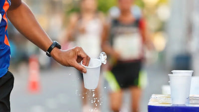 How should a runner hydrate during a workout?